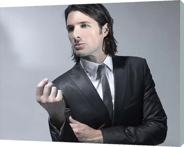 Long-haired man in his early thirties wearing a suit, fashion shoot