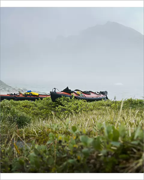 Greenland, Tasiilaq, sea kayaks on misty morning