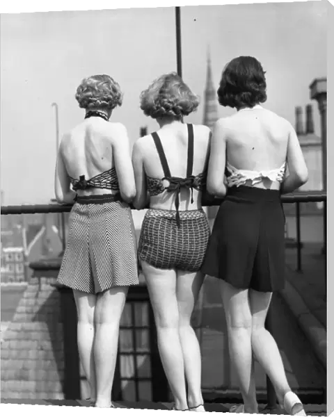 Good View. 1st April 1935: Three models wearing two-piece swimsuits with tailored shorts