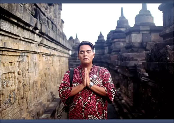 Asian man in traditional dress posed at Borobudur temple