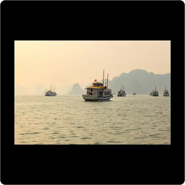 boats cruising around karst in the world famous place halong bay in north Vietnam