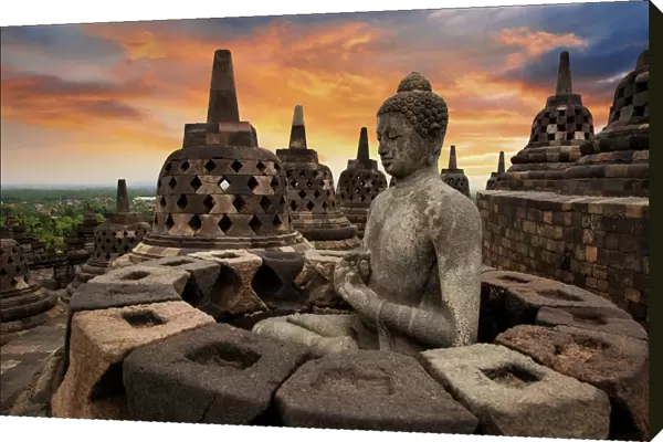 Sunrise with a Buddha Statue with the Hand Position of Dharmachakra Mudra in Borobudur, Magelang, Central Java, Indonesia