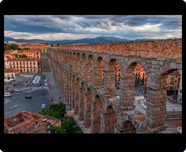 Panoramic view of Aqueduct of Segovia illuminated by the setting sun, Spain