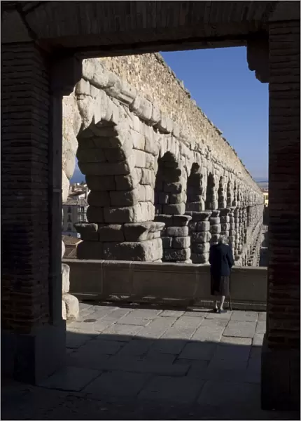 Elderly woman looking at the aqueduct of Segovia