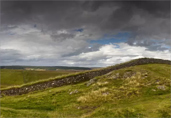 A Person Sits On A Hill With A View Of Hadrians Wall