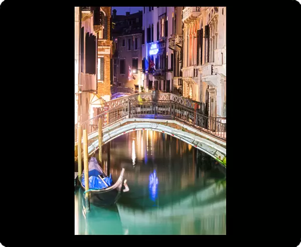 Canal at night with gondola, Venice, Italy