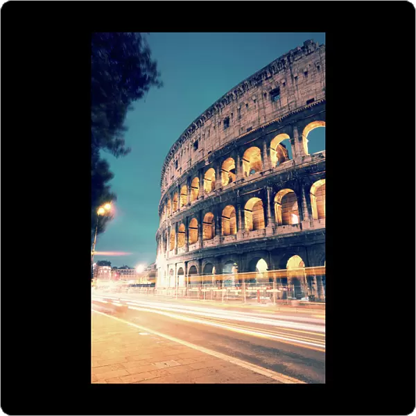 Colosseum at night with light trails from cars
