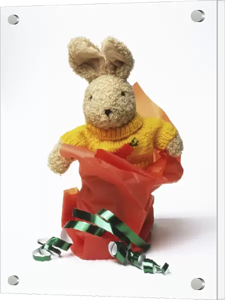 Toy rabbit with wrapping paper and ribbons