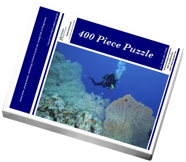 Scuba diver, young woman, swimming in front of coral reef, orange fish in foreground