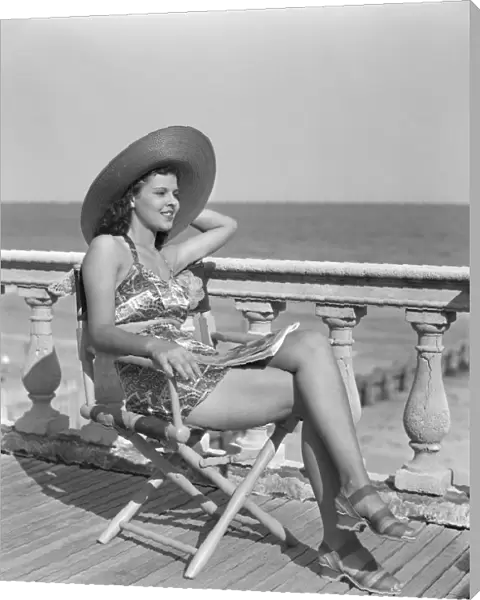 Woman wearing a hat, posing at the beach
