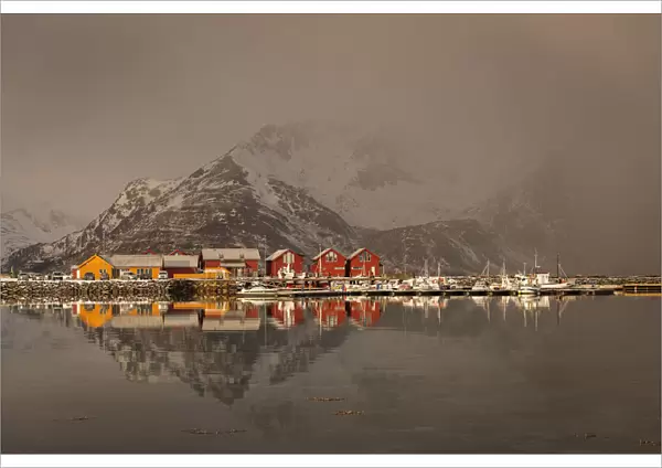Beautiful landscape with clouds, fog, water, reflectaion in background at Lofoten Island, Norway