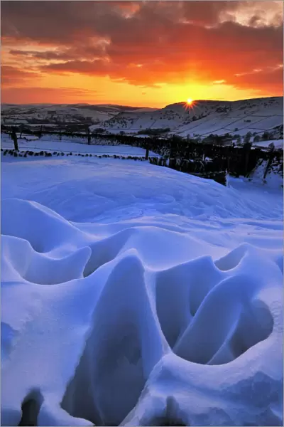 Strange natural snow formations at sunset with the Derbyshire countryside. UK