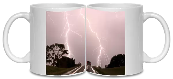 Driving into the storm, Double lightning bolts over highway. Nebraska. USA