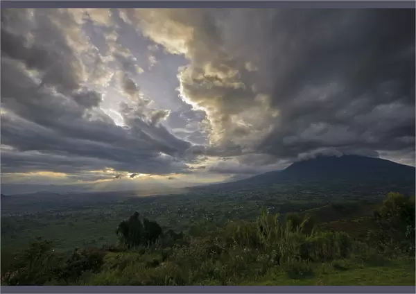 Sunset over the Virunga Mountains of the Volcanoes National Park in Rwanda with the rural settlements dotting the landscape
