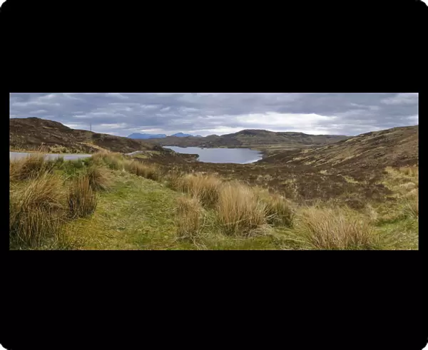 Loch Dhughaill towards the distant Cuillin Hills, Sleat Peninsula, near the town of Tarskavaig, Isle of Skye, Highland, Scotland, United Kingdom, Europe