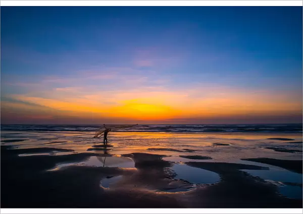 One fisherman hanging fishing tool on the beach at dawn