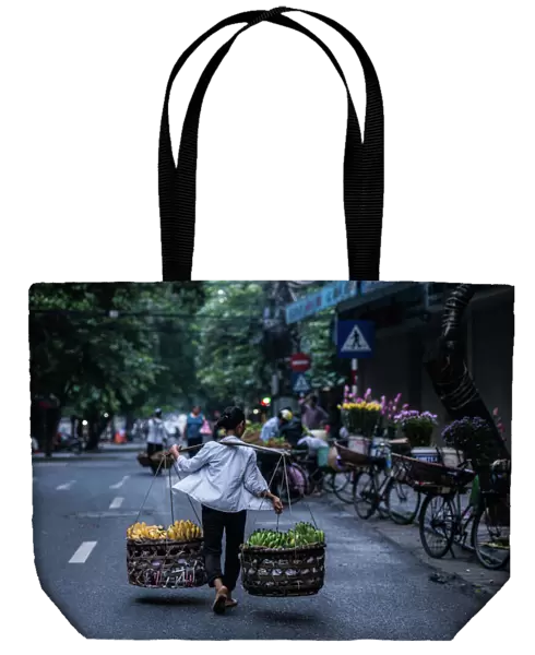 A burden woman in Hanoi street, Vietnam