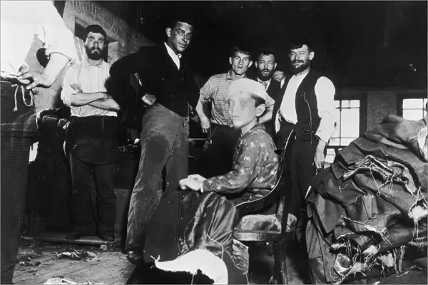 Sweatshop. A Photograph of Young Boy and Several Male Workers in a Sweatshop by Jacob Riis