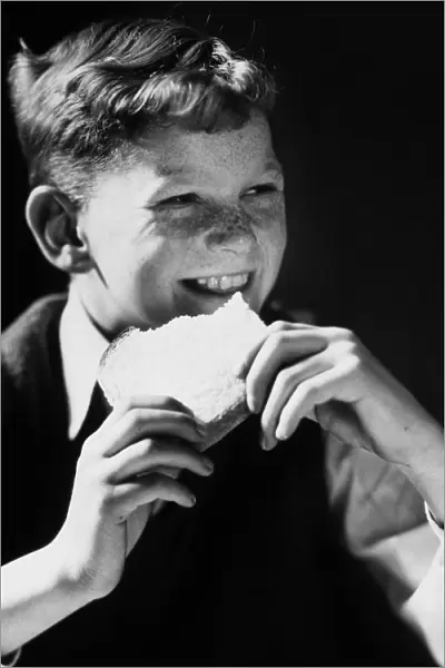 FRECKLE FACED BOY EATING SLICED BREAD