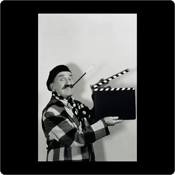 FILM DIRECTOR HOLDING CLAPBOARD