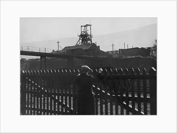 Idle Pit. A man looks over a fence to the deserted Gorki pit near Mountain Ash