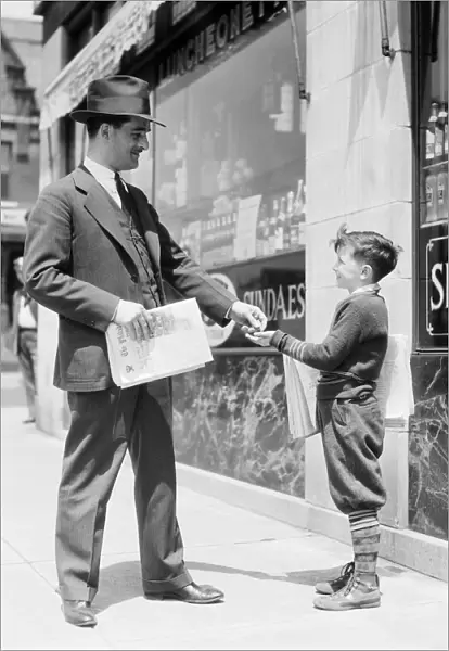 Newspaper boy selling paper to businessman, Philadelphia