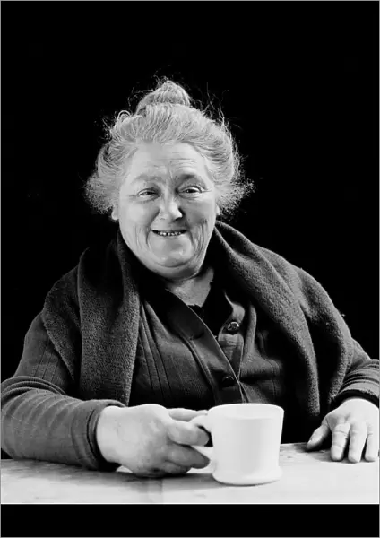 Elderly woman smiling, holding coffee cup, portrait