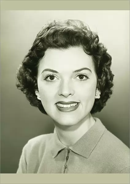 Smiling woman in studio, (B&W), close-up, portrait