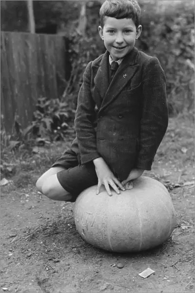 Edward Harrison from North Cray, Kent, poses with the pumpkin that he grew. 1938
