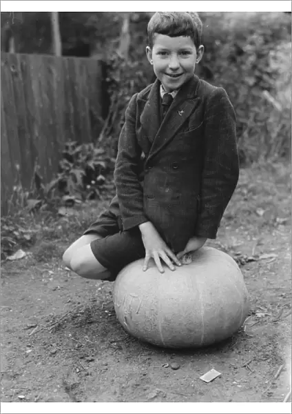 Edward Harrison from North Cray, Kent, poses with the pumpkin that he grew. 1938