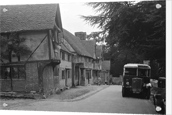 A bus in the village of Chiddingstone, Kent, showing the old cottages