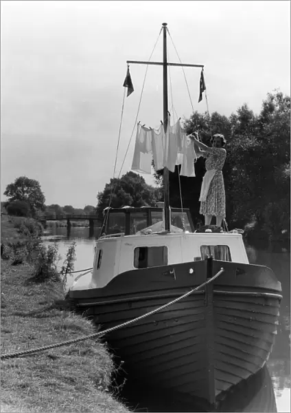 Washing day on holiday - Mrs M Usborne hanging out the washing around the mast of