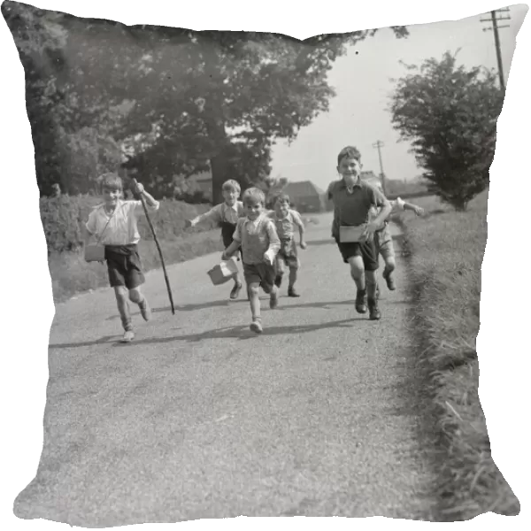 Evacuated children in Wye, Kent, running down a country road. 1939  /  40