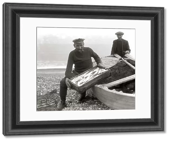 The Coxswain of the Aldeburgh lifeboat, Charlie Mann, with a catch of herrings
