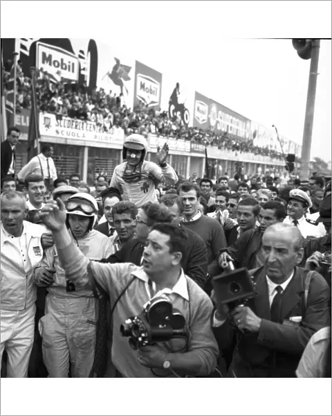 John Surtees and Lorenzo Bandini are mobbed by spectators after the finish of the