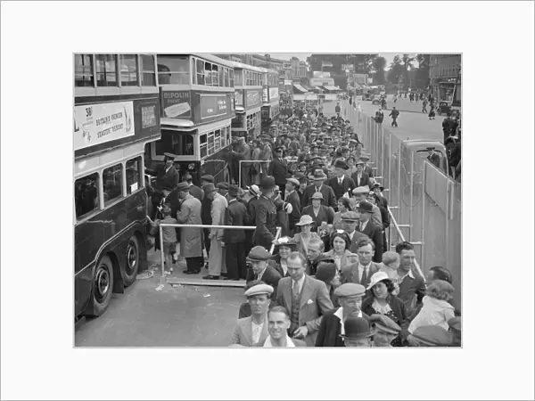 The Epsom Derby Summer Race Meeting. Derby Day crowds boarding buses at Morden
