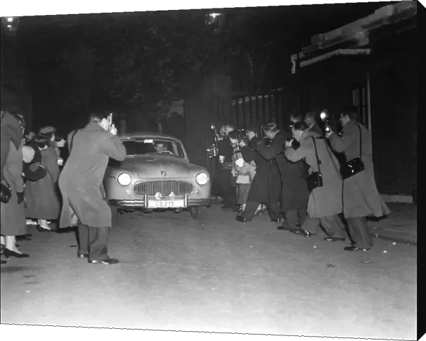 A host of press photographers descend upon the car belonging to Group Captain Peter