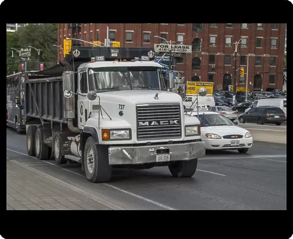 Mack 8 wheeled rigid tipper truck in down town Toronto traffic