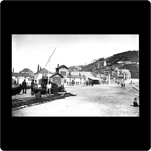The Lifeboat station and neighbouring buildings viewed from the quayside, East Looe, Cornwall. After 1891