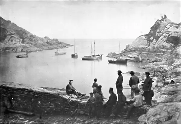 The outer harbour approach with boats off Chapel Rock, Polperro, Cornwall. Probably 1860s-1870s