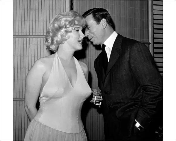 French Actor and Singer Yves Montand Whispers to Marilyn Monroe
