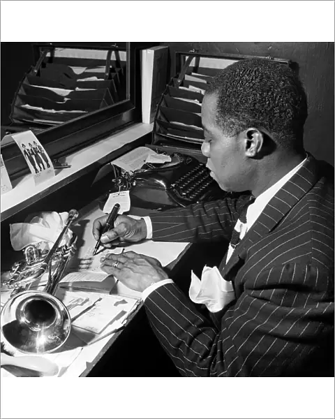 Louis Armstrong, writing a partition in his dressing room