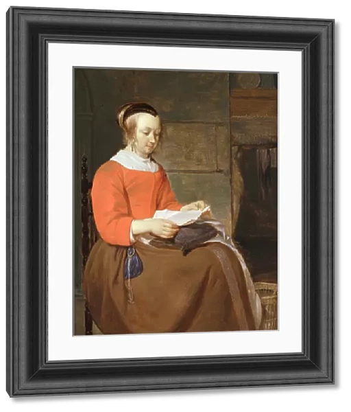 A young woman seated in an interior, reading a letter (oil on panel)