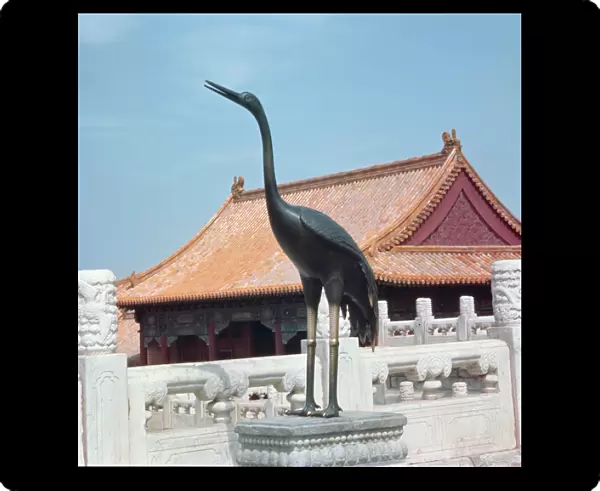 Statue of a stork with a side pavilion of the Hall of Supreme Harmony in the background