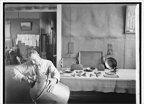 Man cutting up a bootleggers keg during prohibition era, 1918-28 (b  /  w photo)