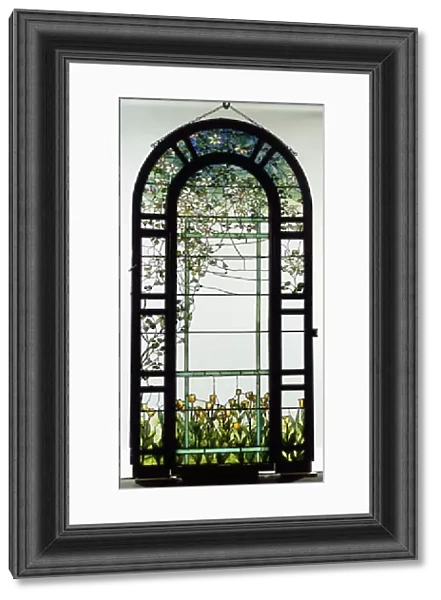 A leaded glass trellised window depicting clematis vines