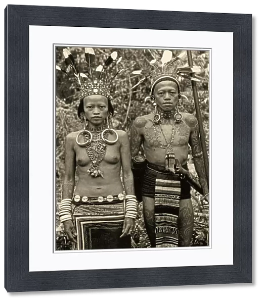 Dayak couple in traditional dress and tattoos, c. 1920 (b  /  w photo)