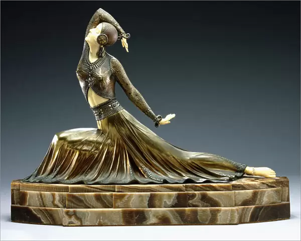 A figure of a dancer, early 20th century (cold-painted bronze and ivory, brown onyx base)