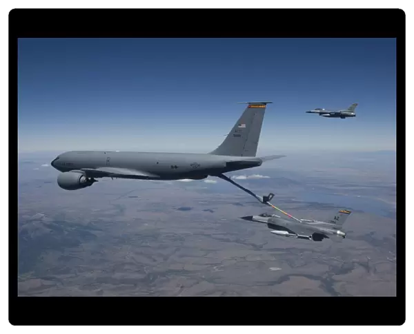 Two F-16 Fighting Falcons conduct aerial refueling with a KC-135 Stratotanker