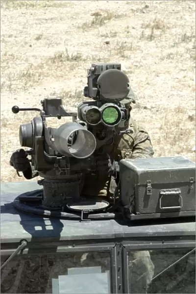 A U. S. Marine looks though the optics of a BGM-71 TOW anti-tank guided missile